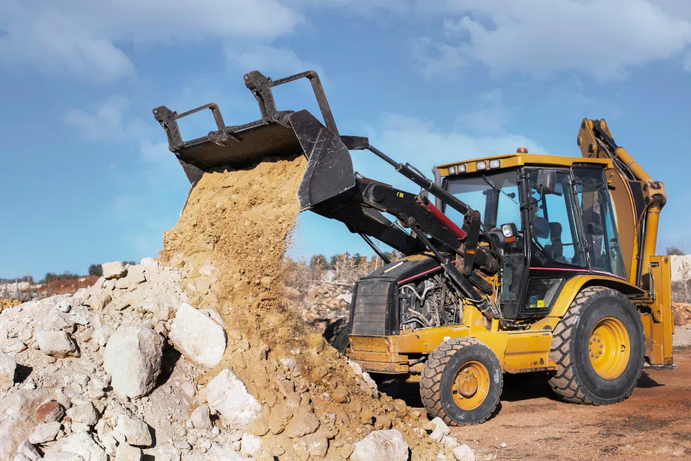 Excavation and earthworks machinery preparing a construction site in Kenya